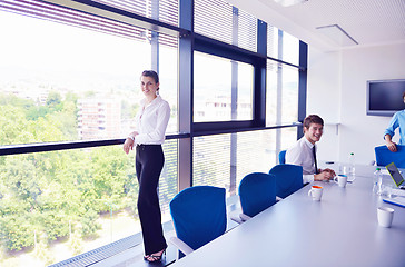 Image showing business woman with her staff in background at office