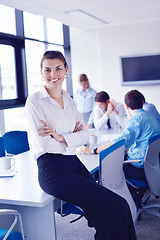 Image showing business woman with her staff in background at office