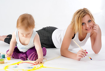 Image showing Pretty young mother and daughter drawing