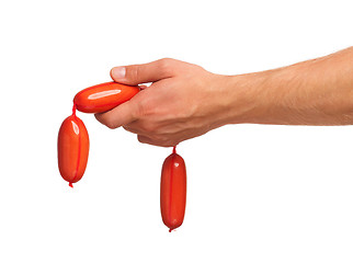 Image showing Hand with sausage