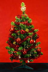 Image showing Decorated christmas tree on red background