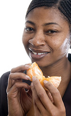 Image showing smiling woman with tangerine