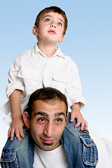 Image showing Child sitting on father's shoulders