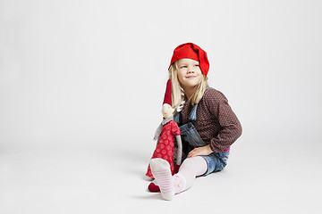 Image showing Smiling girl holding Christmas elf doll