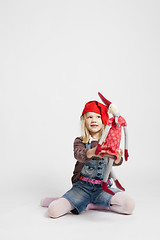 Image showing Smiling girl holding Christmas elf doll