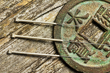 Image showing acupuncture needles on chinese coin