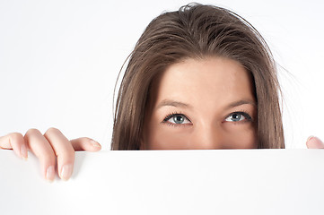 Image showing woman  hiding behind billboard