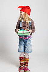 Image showing Happy girl holding Christmas gifts