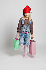 Image showing Smiling girl carrying Christmas shopping bags