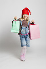 Image showing Smiling girl carrying Christmas shopping bags