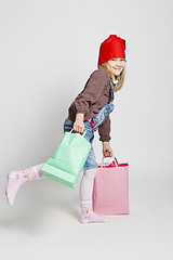 Image showing Smiling girl carrying Christmas shopping bags