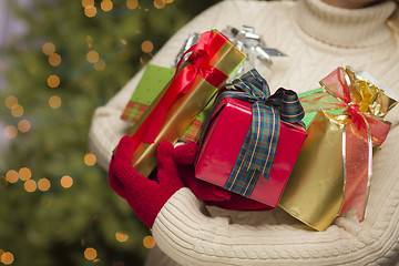 Image showing Woman Wearing Seasonal Red Mittens Holding Christmas Gifts