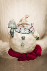 Image showing Woman Wearing Seasonal Red Mittens Holding Glass Snowman 