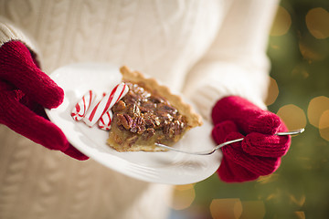 Image showing Woman Wearing Red Mittens Holding Plate of Pecan Pie, Peppermint