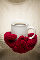 Image showing Woman in Sweater with Red Mittens Holding Cup of Coffee