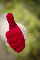 Image showing Woman Wearing Red Mittens Holding Out Thumbs Up Hand Sign