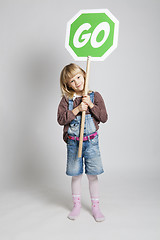Image showing Young girl holding go sign