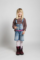 Image showing Happy girl wearing adult sized boots