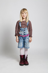 Image showing Happy girl wearing adult sized boots