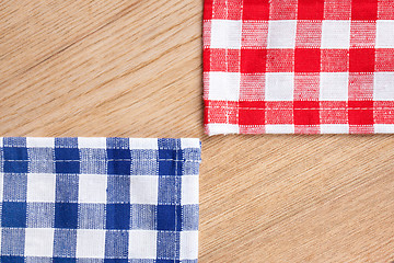 Image showing checkered tablecloth on wooden table