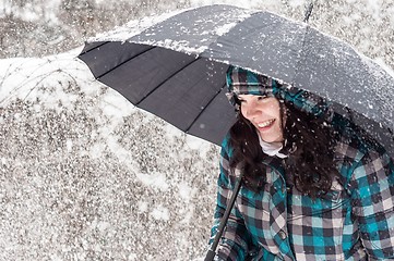 Image showing Girl with umbrella in the snow