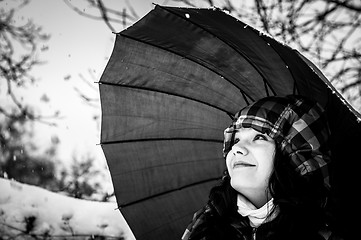 Image showing Girl with umbrella in the snow