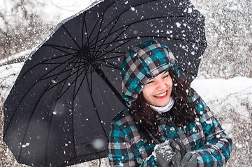 Image showing Girl with umbrella in the snow