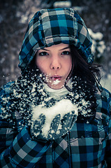 Image showing Attractive young woman with snow in her hand