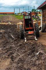 Image showing Red tractor in the mud