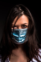 Image showing Young woman in a protective mask