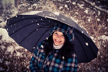 Image showing Girl with umbrella in the snow