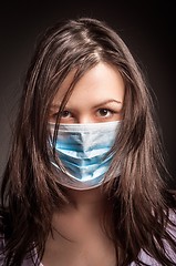 Image showing Young woman in a protective mask