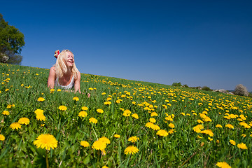 Image showing young woman lying on a meadow