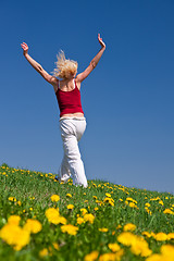 Image showing young woman in red outfit having fun on meadow