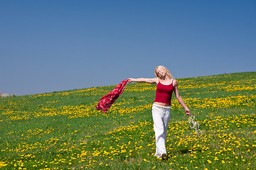 Image showing young woman with a red scarf on a meadow