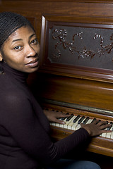 Image showing pretty black woman at piano