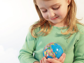 Image showing girl holding globe