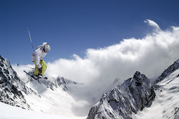 Image showing Freestyle ski jumper with crossed skis