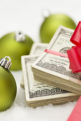 Image showing Stack of Hundred Dollar Bills with Bow Near Christmas Ornaments