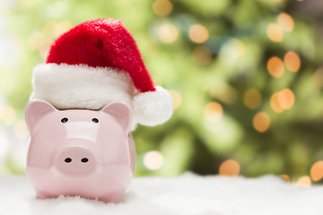 Image showing Pink Piggy Bank with Santa Hat on Snowflakes