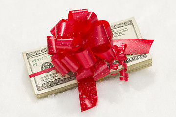 Image showing Stack of Hundred Dollar Bills with Red Ribbon on Snow