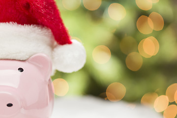 Image showing Pink Piggy Bank with Santa Hat on Snowflakes