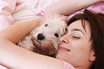 Image showing Dog sleeping on bed 