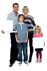 Image showing Family of four. Father and daughter holding pizza boxes.