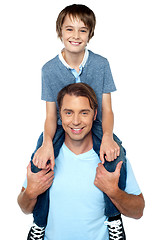 Image showing Adorable young son enjoying piggyback ride