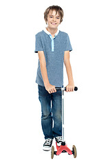 Image showing Smart young boy posing with his push scooter