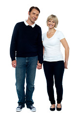 Image showing Middle aged couple posing with hand in hand