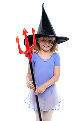 Image showing Cute girl holding pitchfork and wearing witches hat