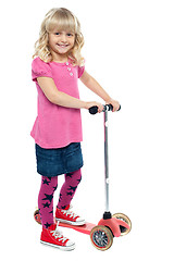 Image showing Little girl enjoying her toy scooter ride