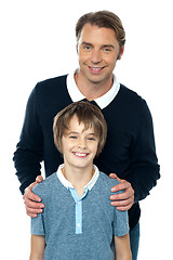 Image showing Man in blue pullover posing with his son